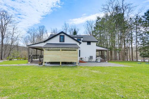 a large white house with a large yard at Hot Tub and Lake Access at Poconos Getaway! in Lake Ariel