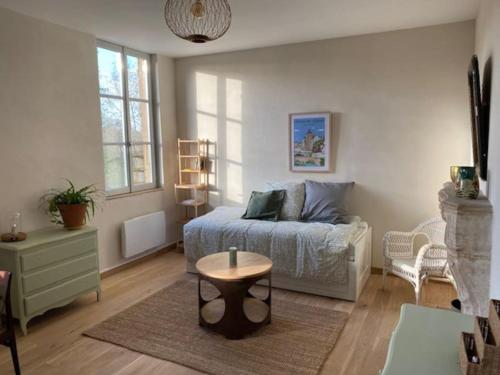 a bedroom with a bed and a table in it at La Tour in Semur-en-Auxois