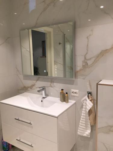 a bathroom with a white sink and a mirror at Villa Skoglund in Stranda