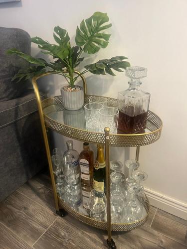 a gold and glass table with bottles and glasses on it at Pringle cottage in Clones