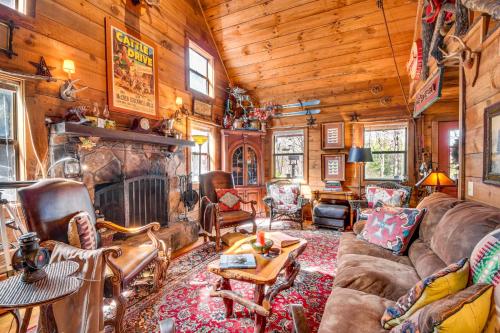 a living room with a couch and a fireplace at Rustic Cabin with Porches 8 Mi to Tallulah Gorge! in Tiger
