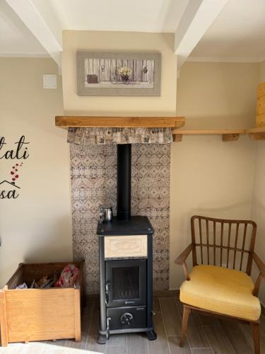 a fireplace in a living room with a stove at La Casa dei Nonni in Sasso dʼOmbrone