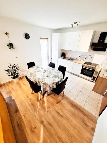 a kitchen and dining room with a table and chairs at Josipa & Jelena Apartment in Senj
