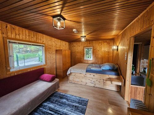 a bedroom with a bed in a wooden cabin at Ferienhaus in Geesthacht-Tesperhude direkt am Waldrand in Geesthacht