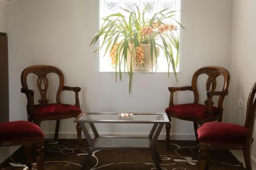 a living room with two chairs and a glass table at B&B SARDES in Cervaro
