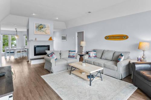 a living room with a couch and a table at Nautical Watch on Harbor Island in Oceanmarsh Subdivision