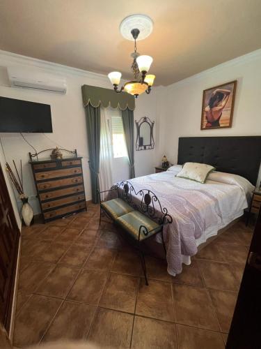 a bedroom with a bed and a dresser in it at RURAL EL SANTISCAL in Arcos de la Frontera