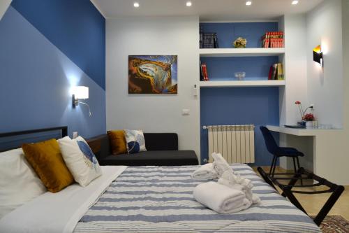 a bedroom with a bed with a blue wall at Casa Grazia - Guest House - in Reggio Calabria