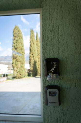 a clock on a wall next to a window at B&B SARDES in Cervaro