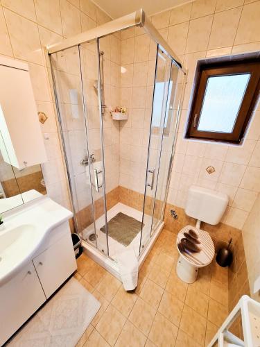 a bathroom with a shower and a sink at Josipa & Jelena Apartment in Senj