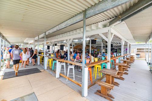 a group of people sitting in a pavilion at a beach at Four Corners RV Resort in Antioch