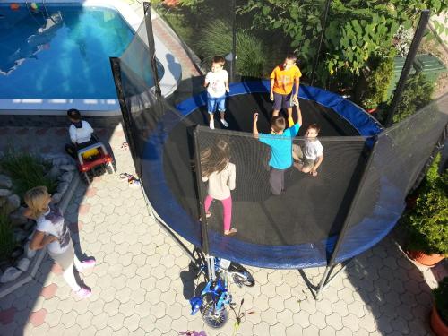 a group of children playing on a trampoline at Apartments Nikolić in Soko Banja