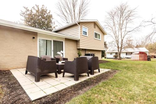 a patio with chairs and a table in front of a house at 5 bedrooms with 4 Full Bath Fire Pit BBQ and Plush Amen on 1 2 acre in Silver Spring