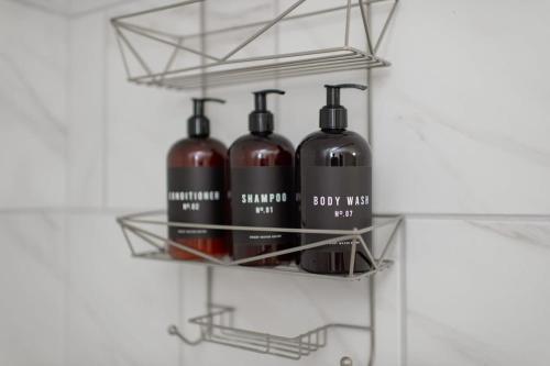 a shelf with four bottles of wine on it at 5 bedrooms with 4 Full Bath Fire Pit BBQ and Plush Amen on 1 2 acre in Silver Spring