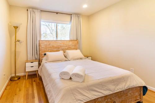 a bedroom with a large bed with towels on it at 5 bedrooms with 4 Full Bath Fire Pit BBQ and Plush Amen on 1 2 acre in Silver Spring