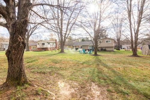 a group of trees in a yard with houses at 5 bedrooms with 4 Full Bath Fire Pit BBQ and Plush Amen on 1 2 acre in Silver Spring