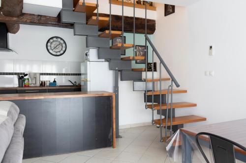 a staircase in the living room of a house at Duplex la galerie in Saint-Herblain