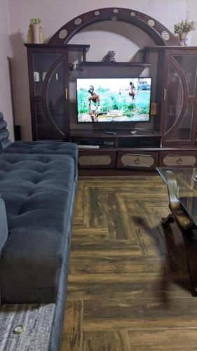 a living room with a couch and a flat screen tv at Royal villas in Ruhengeri