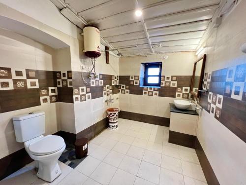a bathroom with a toilet and a sink at The Boho Heritage near Mall Road in Mussoorie