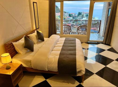 a bedroom with a bed with a view of a balcony at The Boho Heritage near Mall Road in Mussoorie