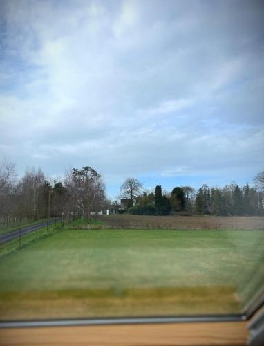 a view of a field from a train window at The Gate House, Kilmullen in Portarlington