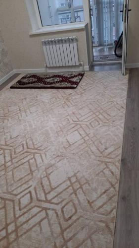 an empty room with a tile floor with a door at ElSAR guesthouse in Osh