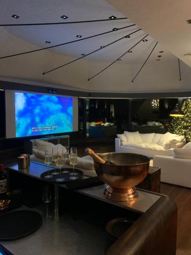 a living room with couches and a large tv at Cave Hotel & Golf Resort in Faversham
