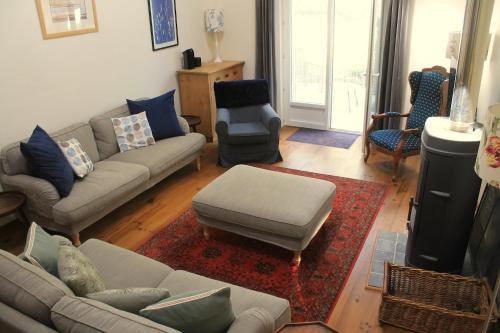 a living room with two couches and a rug at Cha16 - Nanteuil En Vallee - Touchbaudrand in Messeux