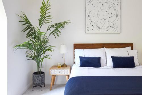 a bedroom with a bed and a potted plant at No 5 Old Church in Ventnor