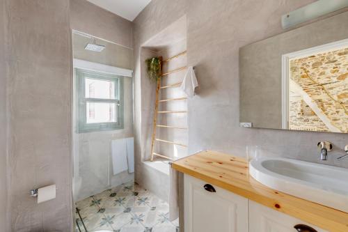 a bathroom with a sink and a shower and a tub at ArtdecoSyros Superior in Ano Syros