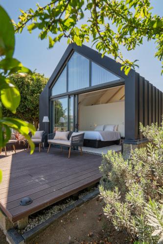 a bedroom in a glass house with a bed at FONTE SANTA Manor House in Vila Nova de Gaia