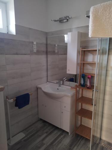 a small bathroom with a sink and a ladder at Gönyüi álom kuckó in Gönyů