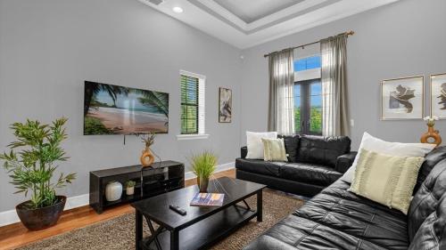 a living room with a couch and a table at Florida Getaway - Renovated TownHome by Disney! in Orlando