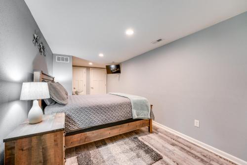 a bedroom with a large bed and a white wall at Pet-Friendly Branson Area Home Hot Tub, Game Room in Reeds Spring