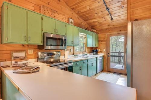 a kitchen with green cabinets and a counter top at Cozy Cabin in Private Location with Hot Tub and Grill! in Blue Ridge