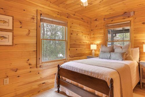 a bedroom with a bed in a log cabin at Cozy Cabin in Private Location with Hot Tub and Grill! in Blue Ridge