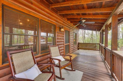 a porch of a cabin with chairs and windows at Cozy Cabin in Private Location with Hot Tub and Grill! in Blue Ridge