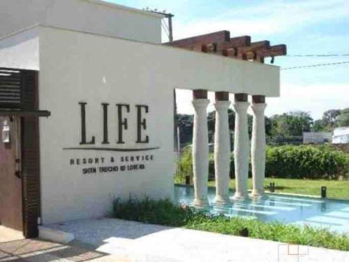 a building with a sign that reads life next to a pool at View467LifeResortBR in Brasilia