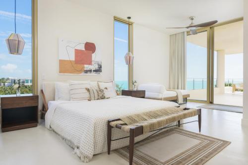 a bedroom with a bed and a large window at Kailoa Villa in Long Bay Hills