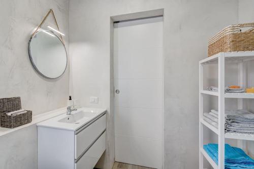 a white bathroom with a sink and a mirror at Ocean View Apartment Montesol I in Adeje