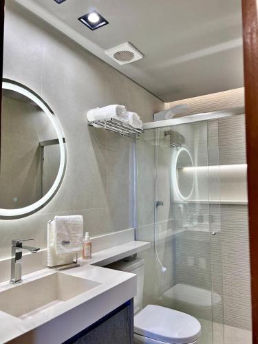 a bathroom with a shower and a toilet and a sink at View467LifeResortBR in Brasilia