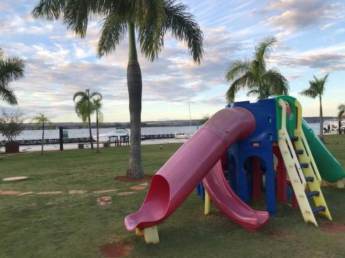 a slide in a park with a palm tree at View467LifeResortBR in Brasilia