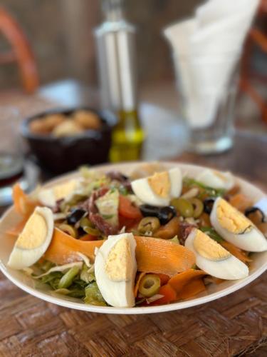 a plate of food with vegetables on a table at Kiwengwa Bungalow Boutique Resort in Kiwengwa