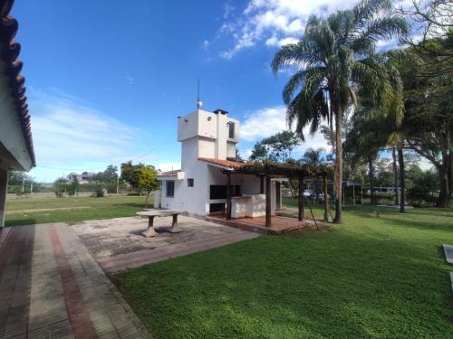 a building with a picnic table in a park at Chalet Del Lago in Termas de Río Hondo