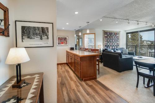 a living room and a dining room and a living room at Trails End Easy Rest Condo: Ski In/Out, Stroll To Main Street in Breckenridge