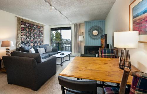 a living room with a couch and a table at Trails End Easy Rest Condo: Ski In/Out, Stroll To Main Street in Breckenridge