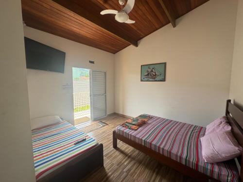 Postel nebo postele na pokoji v ubytování Bapizu Suítes - Ubatuba