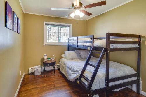 a bedroom with two bunk beds and a ceiling fan at Cozy DuBois Home with Deck about 8 Mi to Treasure Lake! in DuBois