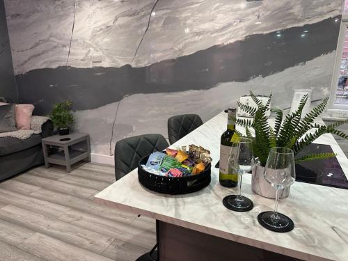 a room with a table with a basket of food and wine at Luxury 2 bedroom apartment in Belper
