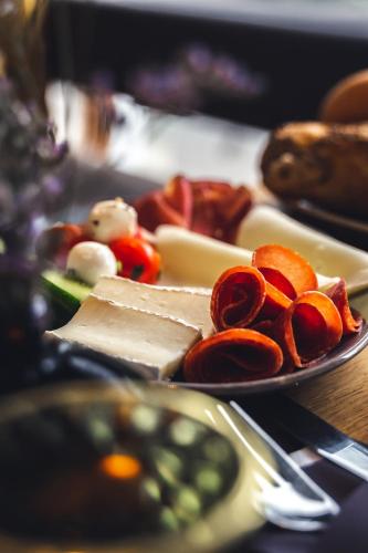 a plate of food with cheese and vegetables on a table at Am Paulusbogen in Passau